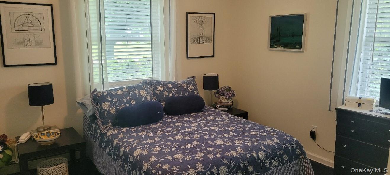 312 Riley Avenue Calverton, NY 11933 - Photo 14 of 30 Second Bedroom featuring two windows with horizontal blinds and sheer curtains, a built-in baseboard.