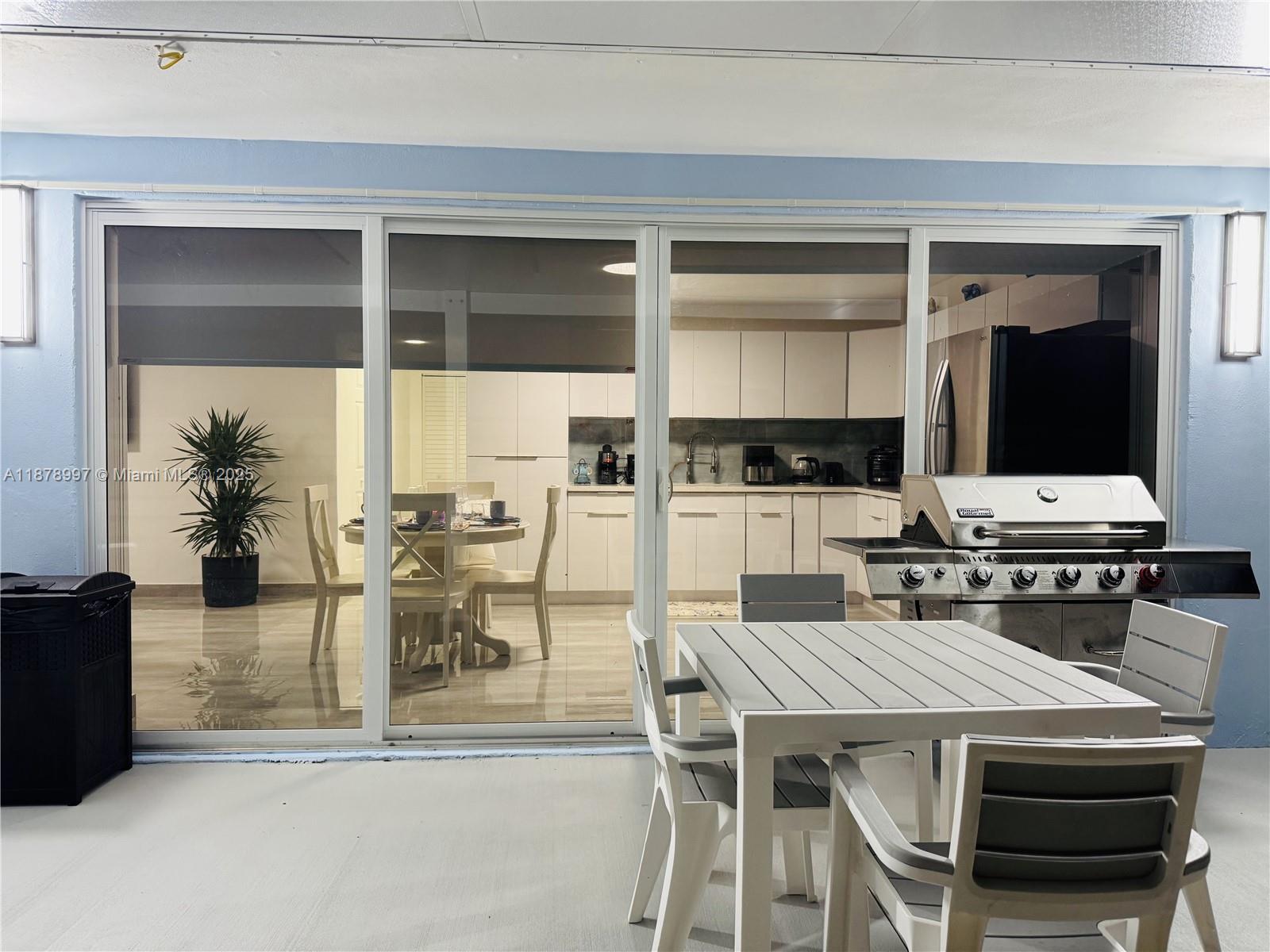 60 Southeast Marlin Avenue Key Largo, FL 33037 - Photo 15 of 40 a dining hall with stainless steel appliances kitchen island granite countertop a dining table and chairs