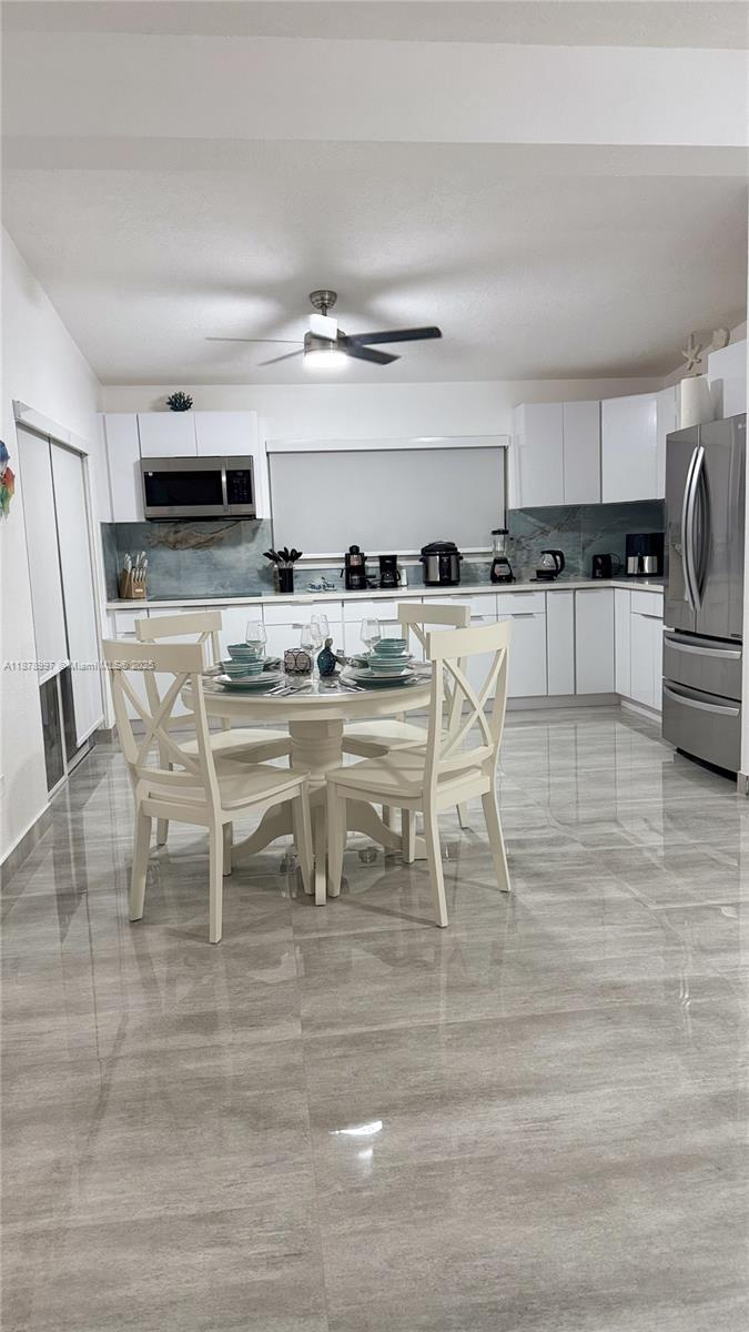 60 Southeast Marlin Avenue Key Largo, FL 33037 - Photo 24 of 40 a living room with stainless steel appliances kitchen island granite countertop furniture and a view of kitchen