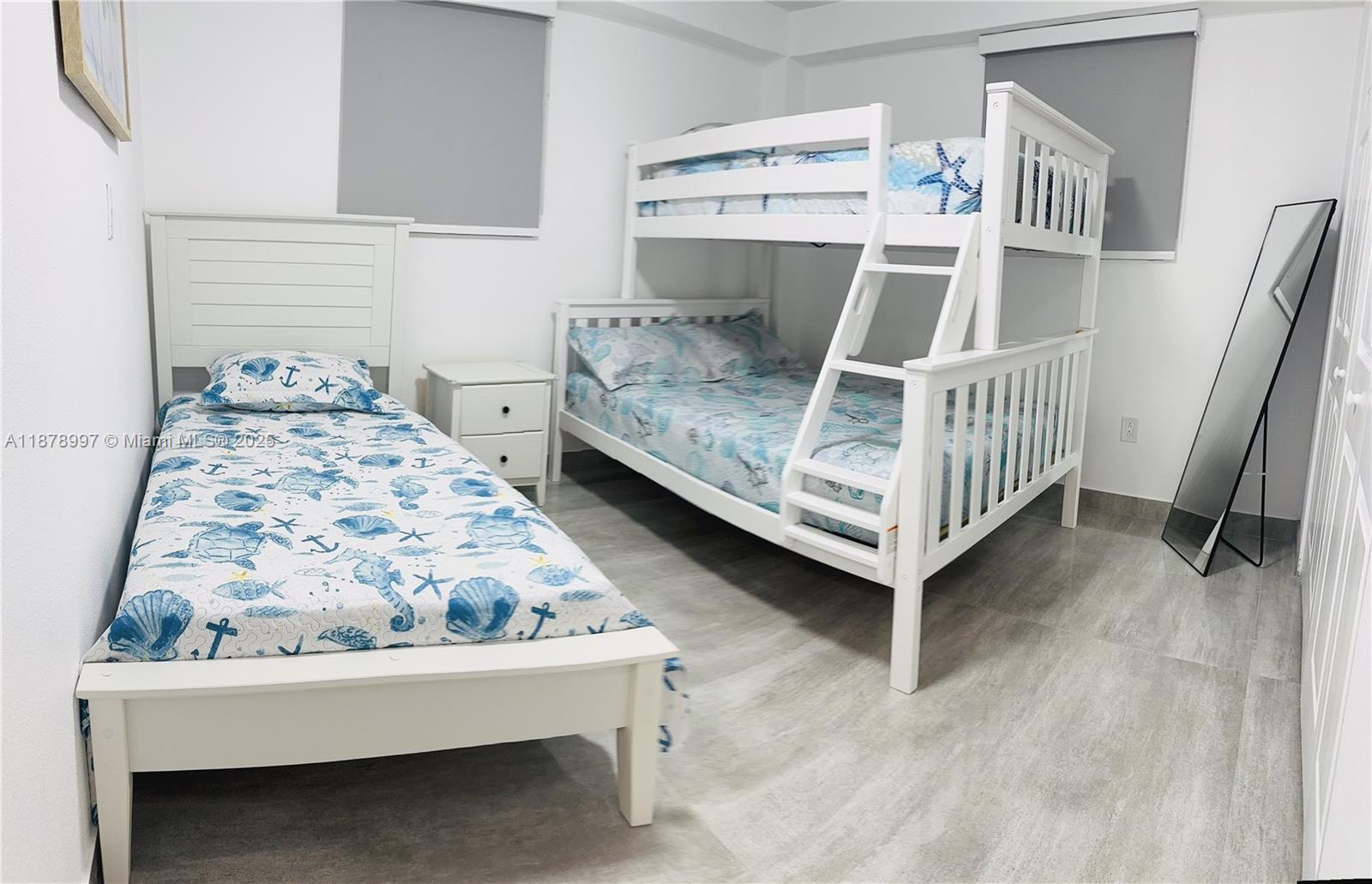 60 Southeast Marlin Avenue Key Largo, FL 33037 - Photo 10 of 40 a bedroom with furniture and a baby crib