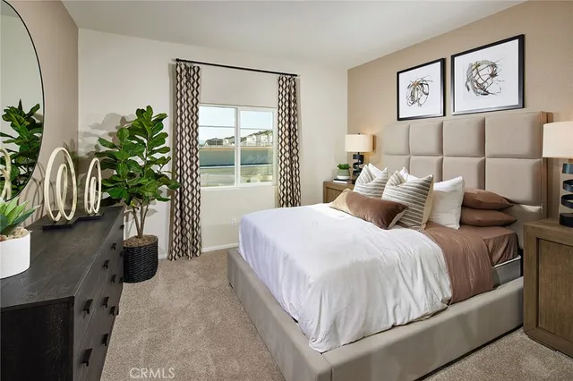 a bedroom with bed and a potted plant