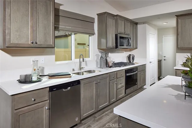 a kitchen with a sink stove and microwave
