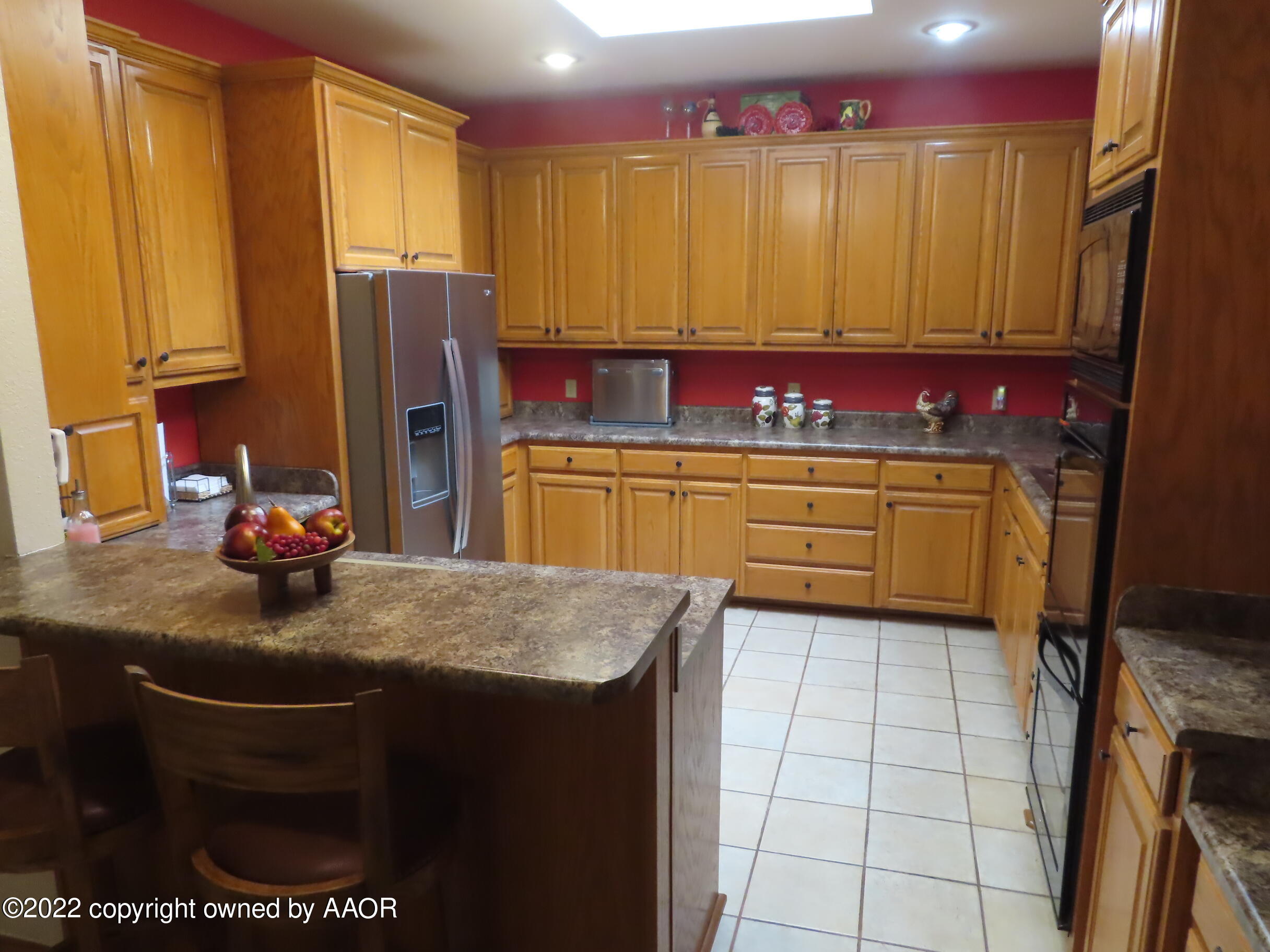 6 Monet Rue Amarillo, TX 79121 - Photo 12 of 13 a kitchen with stainless steel appliances granite countertop a sink refrigerator and cabinets