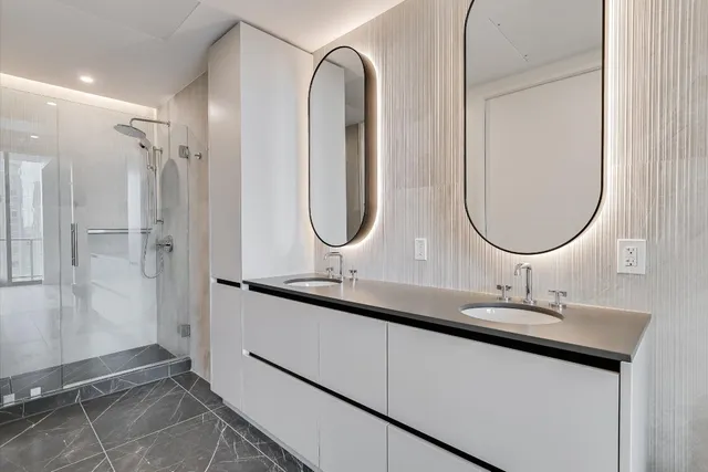 a bathroom with a double vanity sink and a mirror