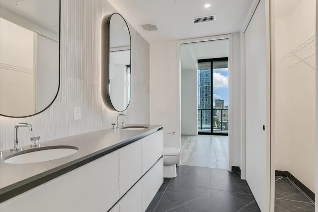 a bathroom with a double vanity sink and a mirror