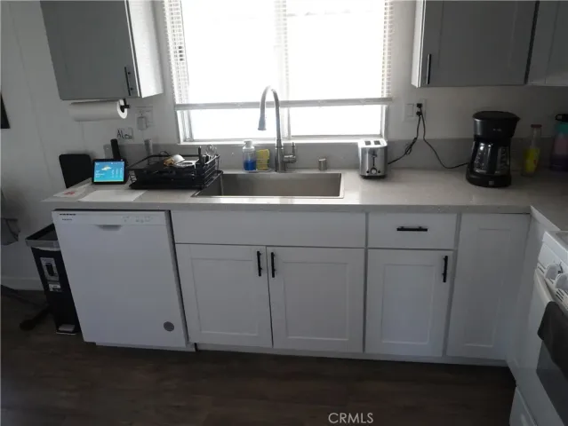 a kitchen with a sink cabinets and a window