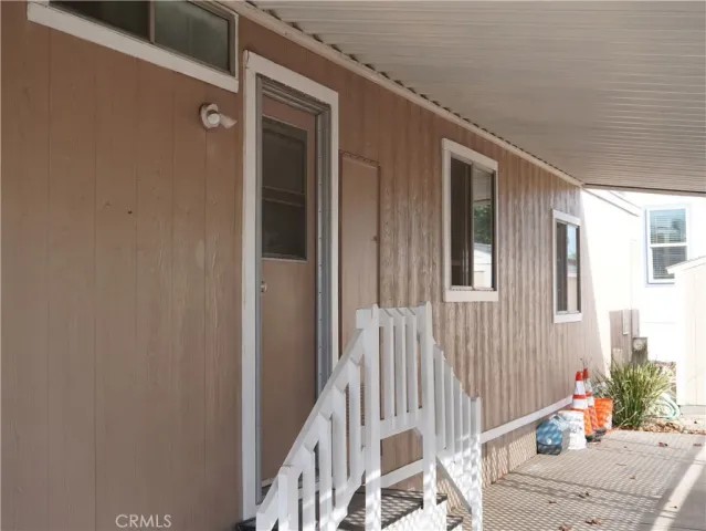 a view of a porch with a table and chairs
