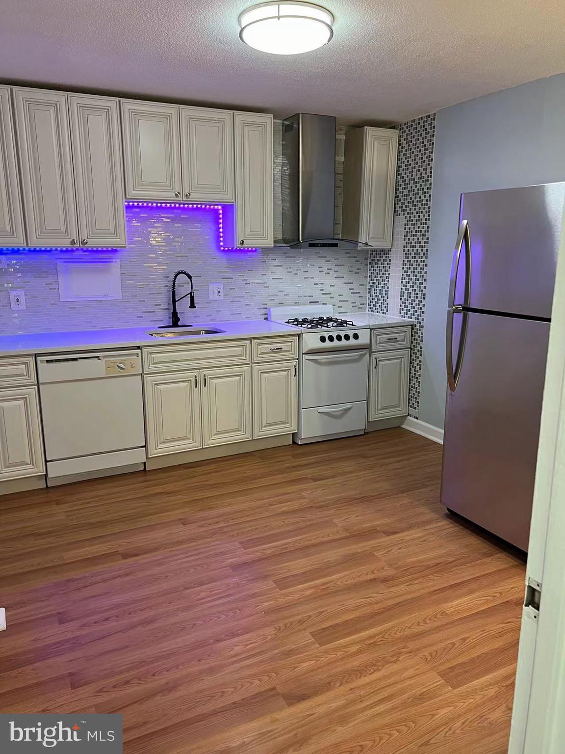 a kitchen with granite countertop a refrigerator and a stove