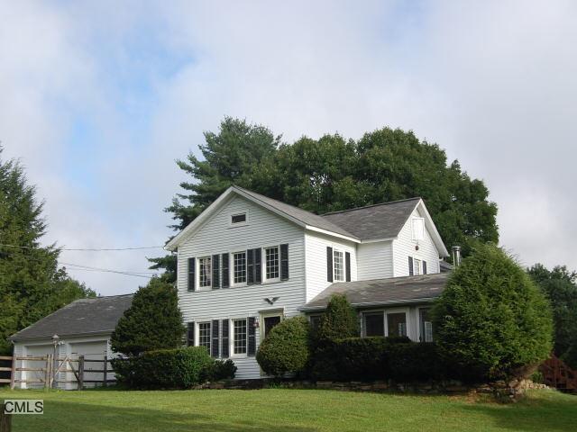 135 Codfish Hill Road Bethel, CT 06801 - Photo 1 of 1 a front view of a house with a garden and trees
