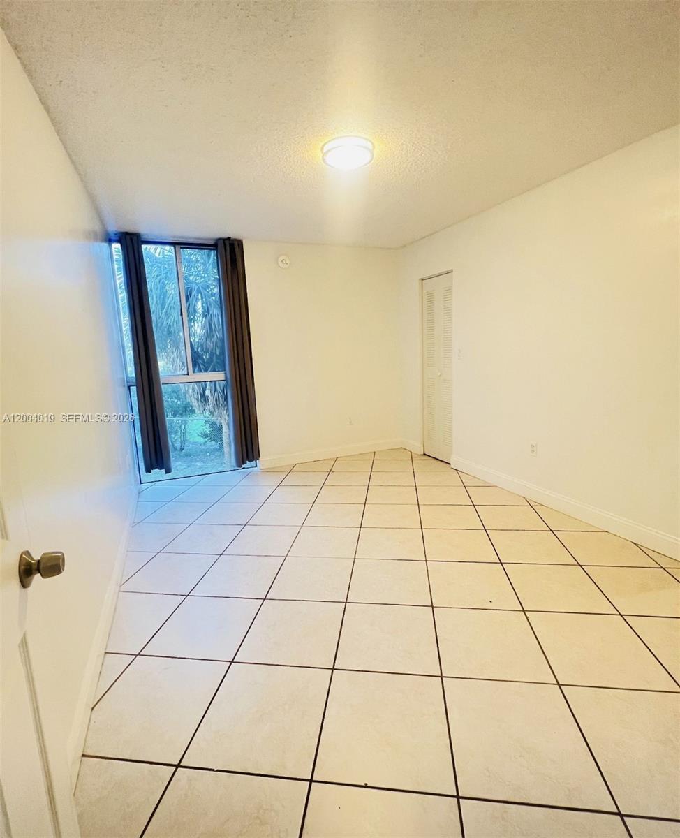 7075 Northwest 186th Street, Unit C205 Hialeah, FL 33015 - Photo 4 of 4 a view of an empty room