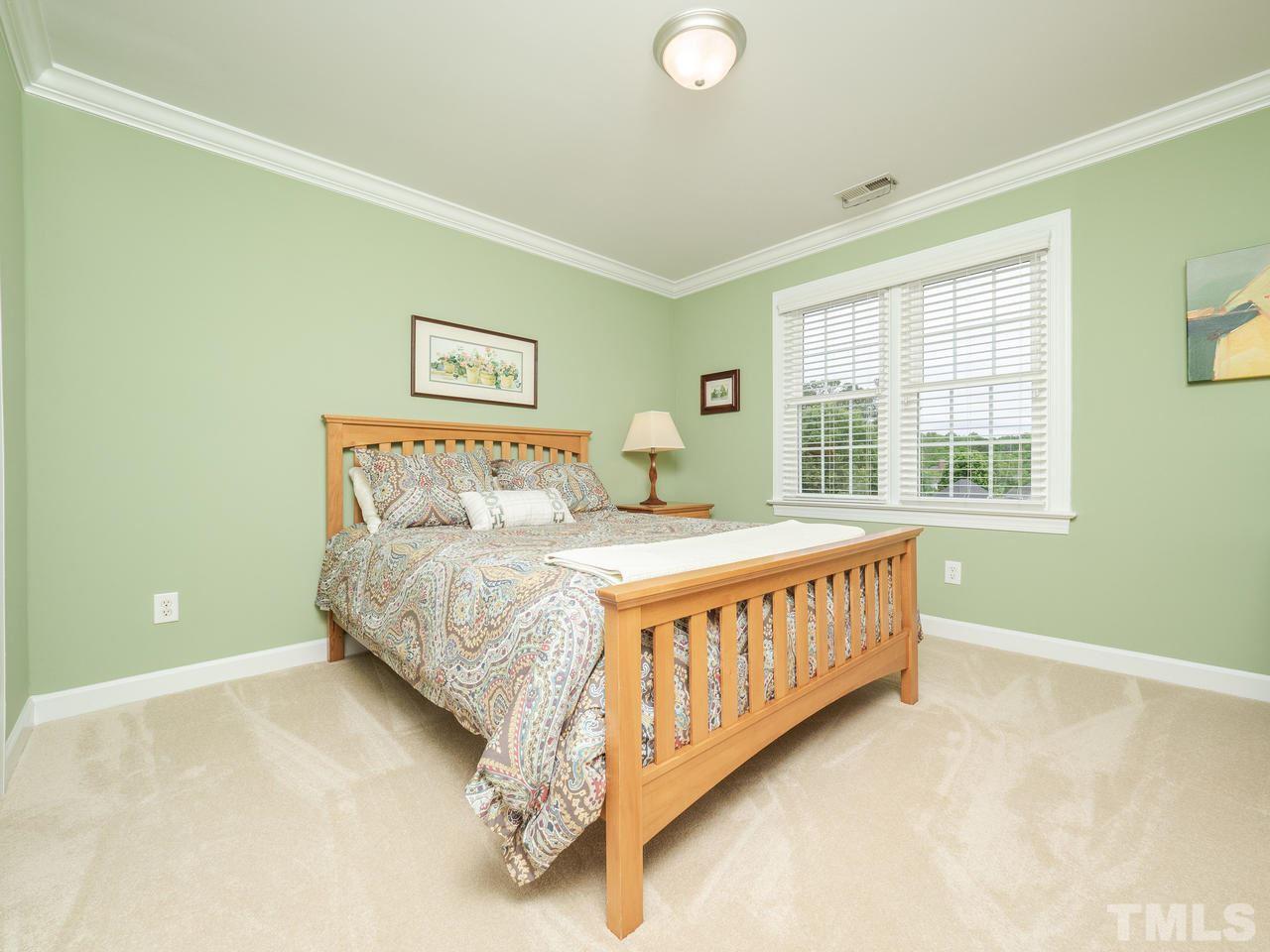 5200 Tallowtree Drive Raleigh, NC 27613 - Photo 22 of 30 a bedroom with a bed and window