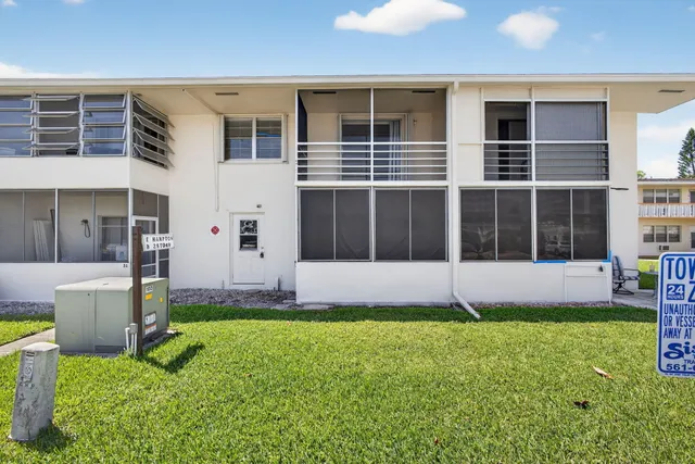 a view of an house with backyard space and a swimming pool