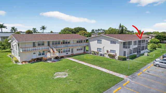 an aerial view of a house with swimming pool and garden