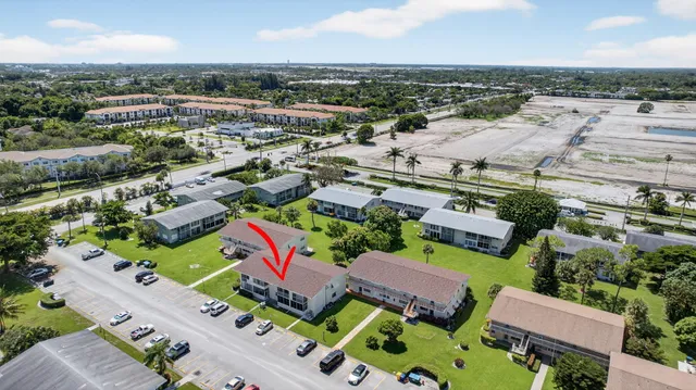 an aerial view of a houses with a swimming pool
