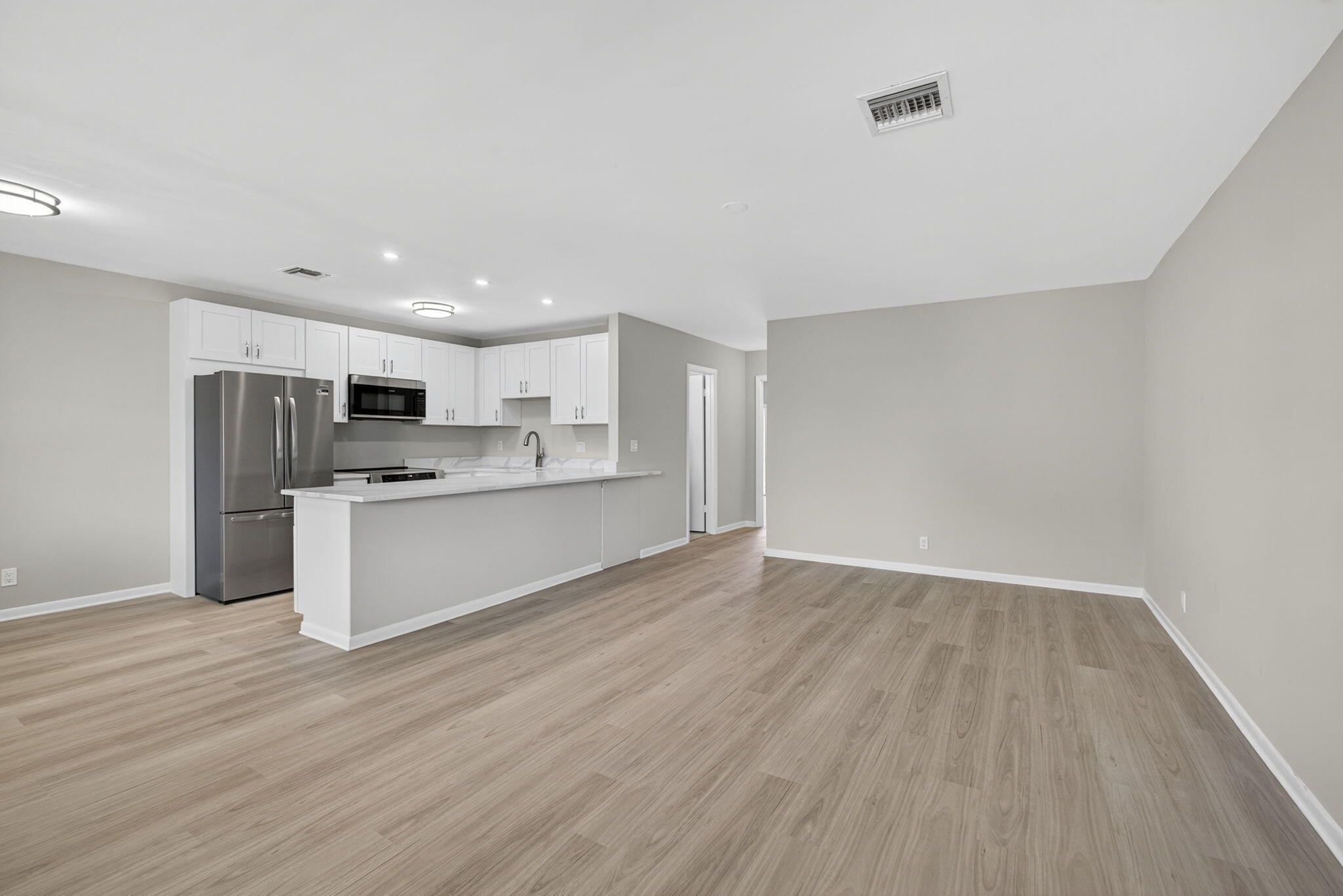 42 Easthampton B West Palm Beach, FL 33417 - Photo 3 of 37 a view of kitchen with stainless steel appliances refrigerator stove microwave and cabinets