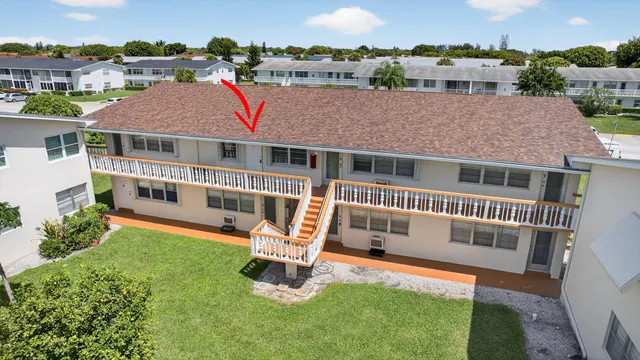 an aerial view of a house with swimming pool and a yard