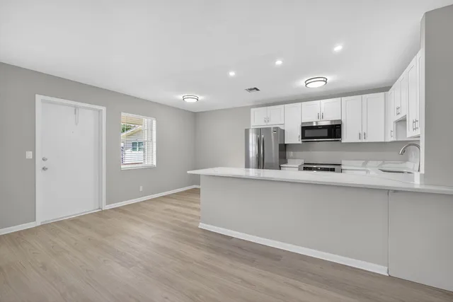a view of kitchen with wooden floor and window