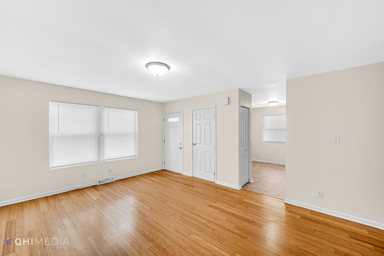 658 Eastview Drive Kankakee, IL 60901 - Photo 4 of 17 an empty room with wooden floor and windows