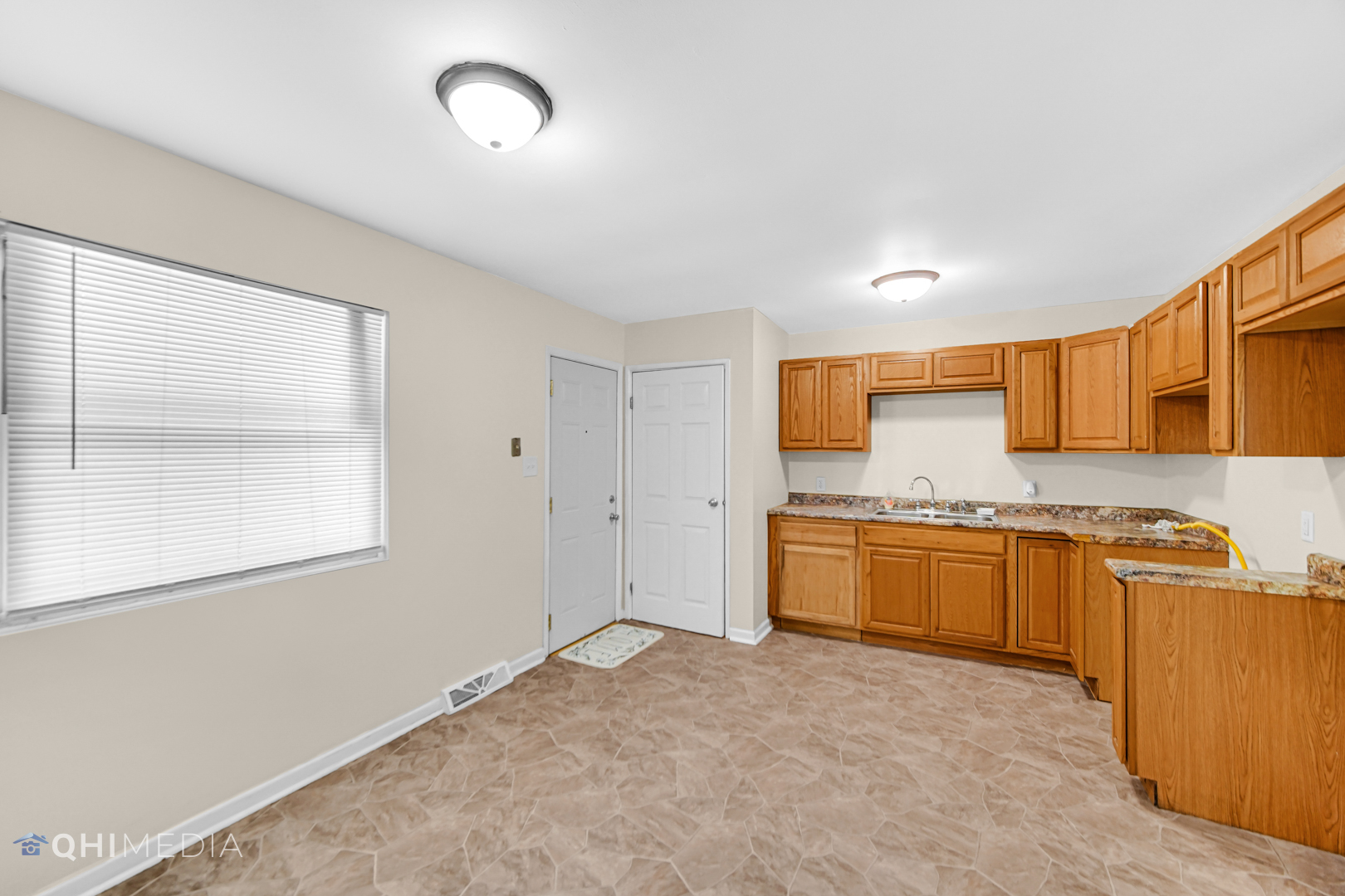 658 Eastview Drive Kankakee, IL 60901 - Photo 6 of 17 a large kitchen with stainless steel appliances granite countertop a stove a sink dishwasher and a refrigerator with wooden cabinets