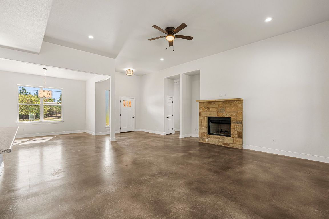 203 Cardinal Loop Paige, TX 78659 - Photo 11 of 36 an empty room with windows and fireplace