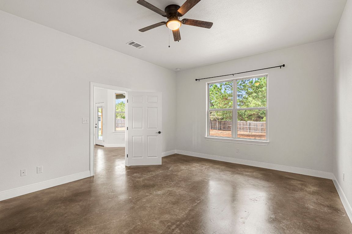 203 Cardinal Loop Paige, TX 78659 - Photo 15 of 36 an empty room with windows and fan