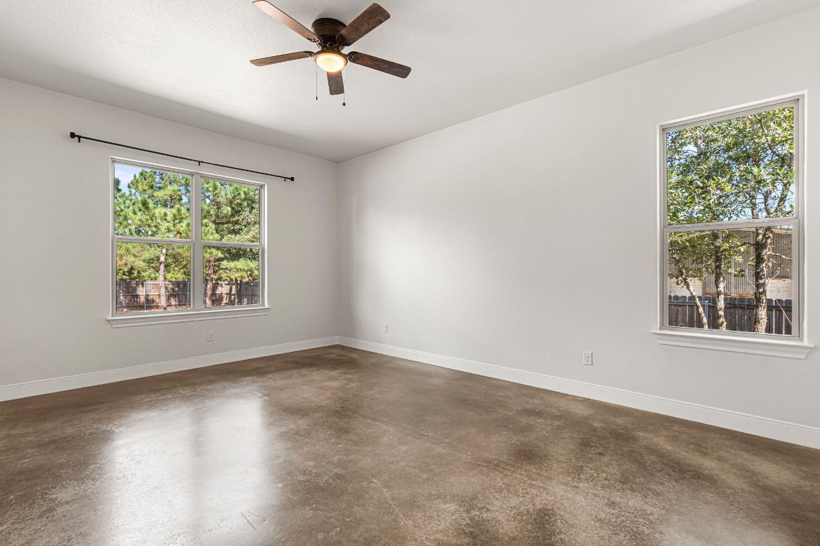 203 Cardinal Loop Paige, TX 78659 - Photo 16 of 36 wooden floor in an empty room with a window