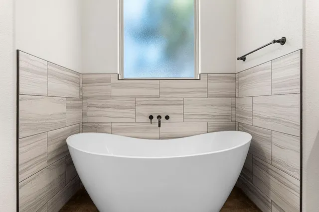 a white bath tub sitting in a bathroom