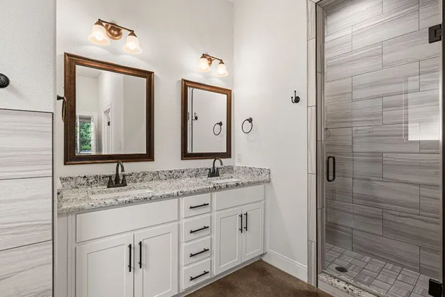 a bathroom with a double vanity sink and mirror
