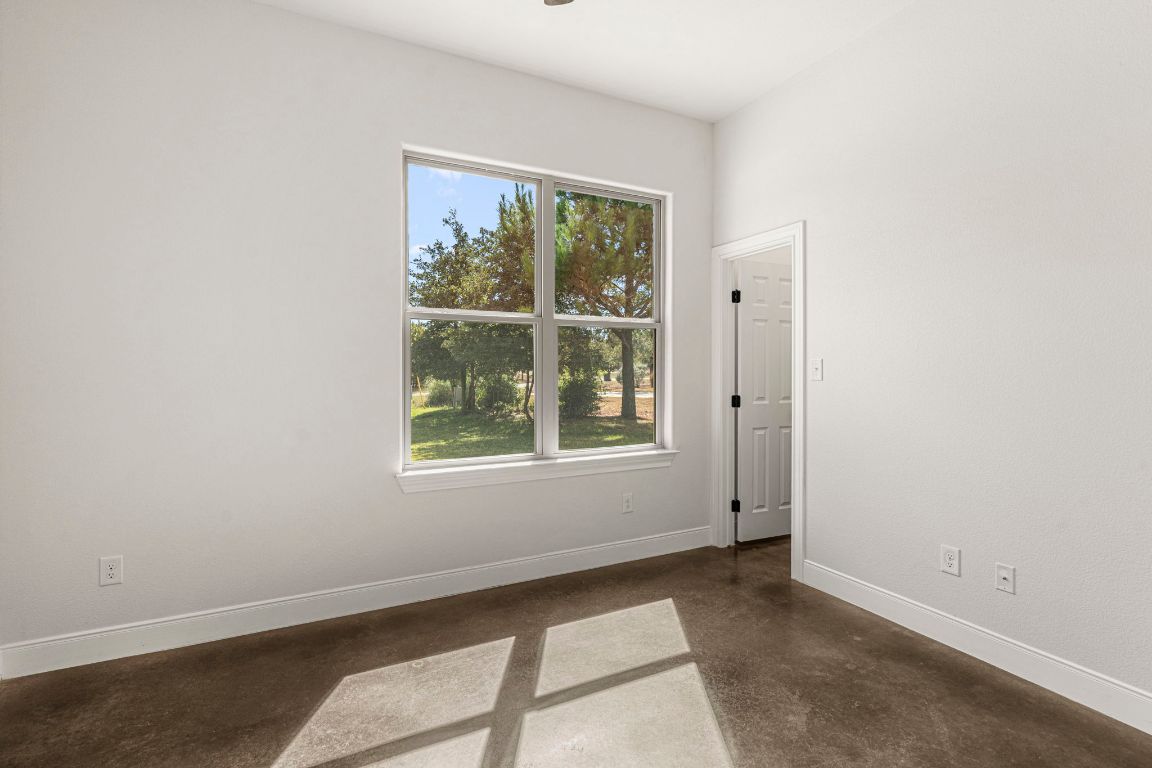 203 Cardinal Loop Paige, TX 78659 - Photo 21 of 36 an empty room with windows
