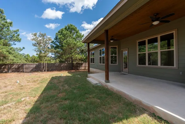 a view of a house with backyard and porch