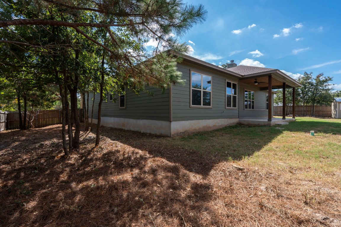 203 Cardinal Loop Paige, TX 78659 - Photo 27 of 36 a front view of a house with garden