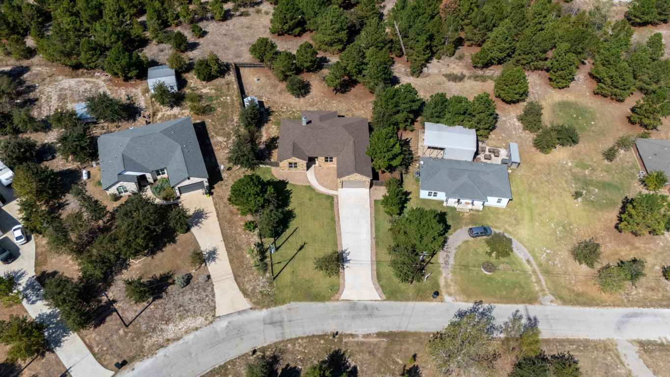 203 Cardinal Loop Paige, TX 78659 - Photo 32 of 36 an aerial view of a house with a swimming pool