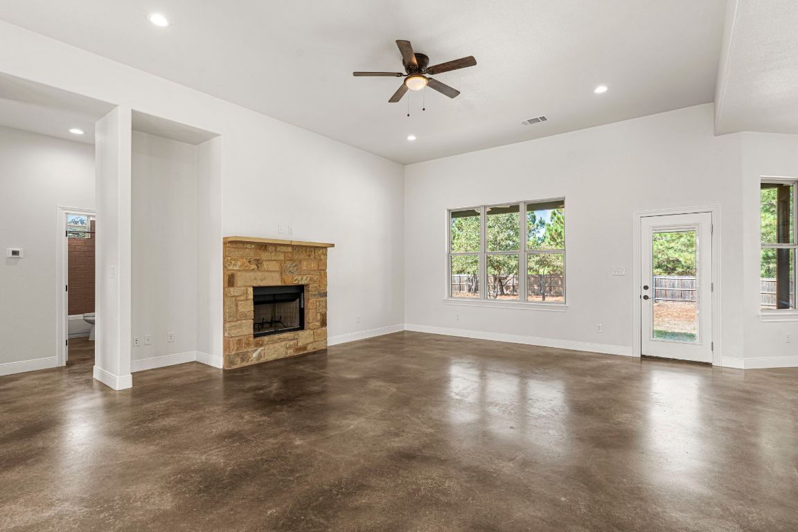 203 Cardinal Loop Paige, TX 78659 - Photo 8 of 36 an empty room with windows and fireplace