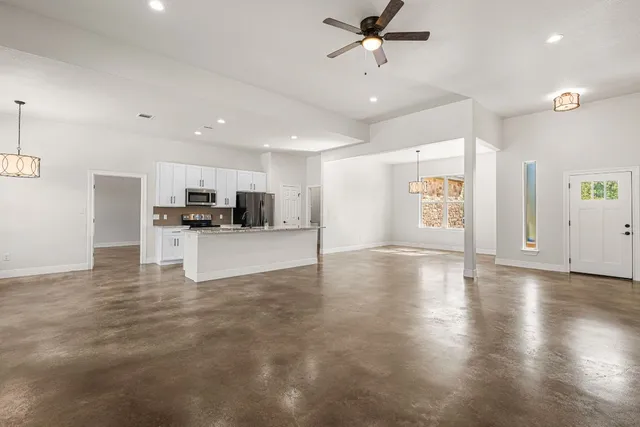 a view of kitchen with a sink a refrigerator and window