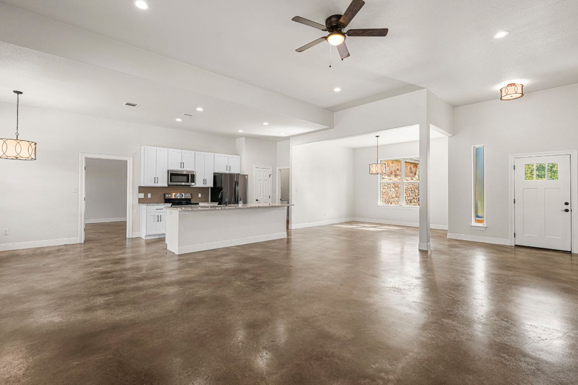 203 Cardinal Loop Paige, TX 78659 - Photo 10 of 36 a view of kitchen with a sink a refrigerator and window
