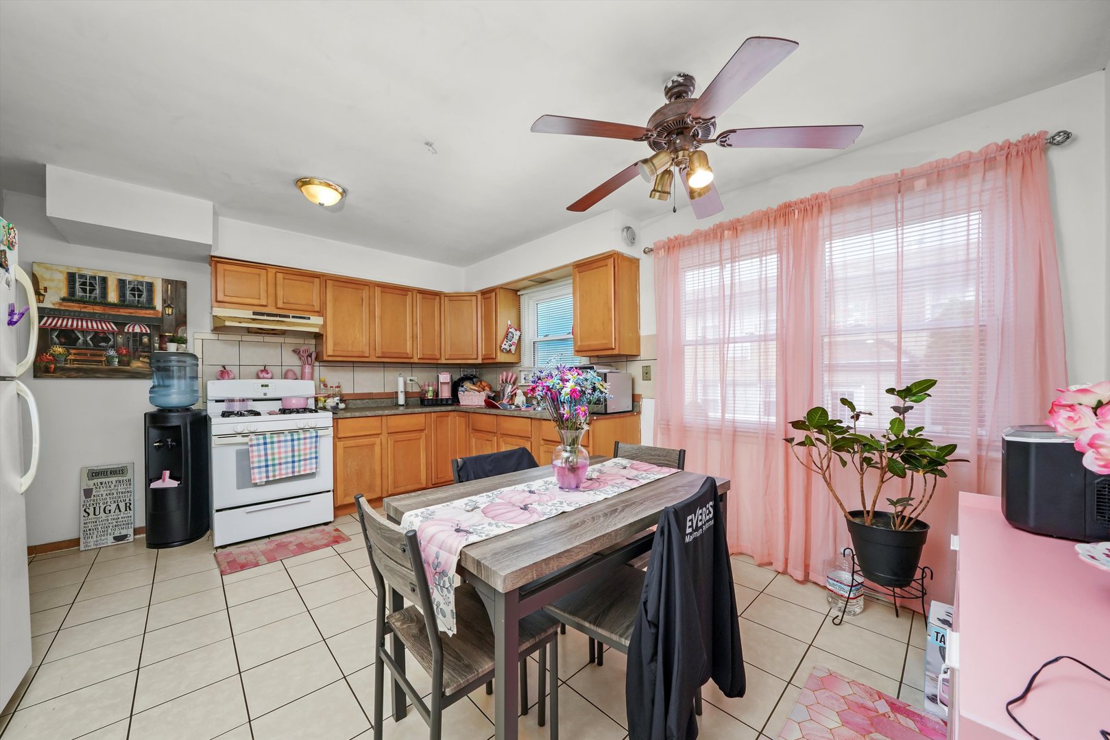 7549 Roberts Road Bridgeview, IL 60455 - Photo 6 of 19 a kitchen with a refrigerator a stove cabinets dining table and chairs