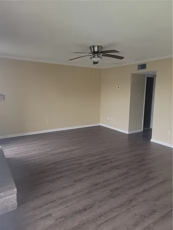 a view of a room with wooden floor