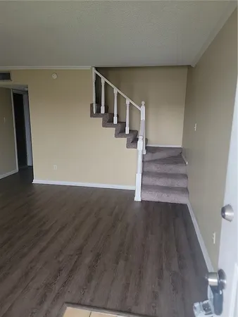 a view of entryway and hall with wooden floor