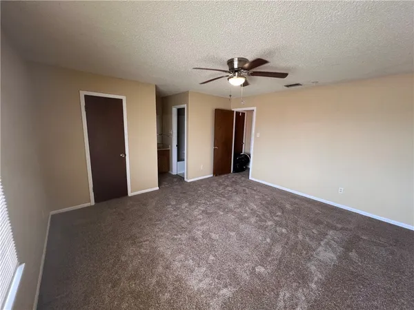 a view of room with a ceiling fan and a ceiling fan