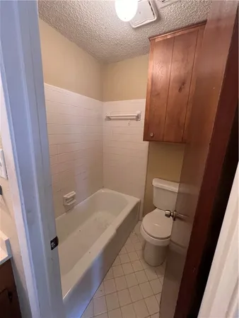 a bath room with a toilet and a shower