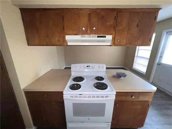 a kitchen with a stove and a refrigerator