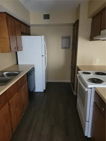a kitchen with a stove a refrigerator and a sink