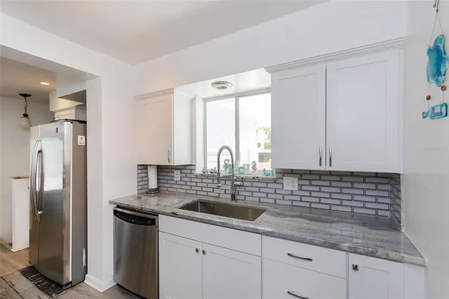 a kitchen with a sink and refrigerator