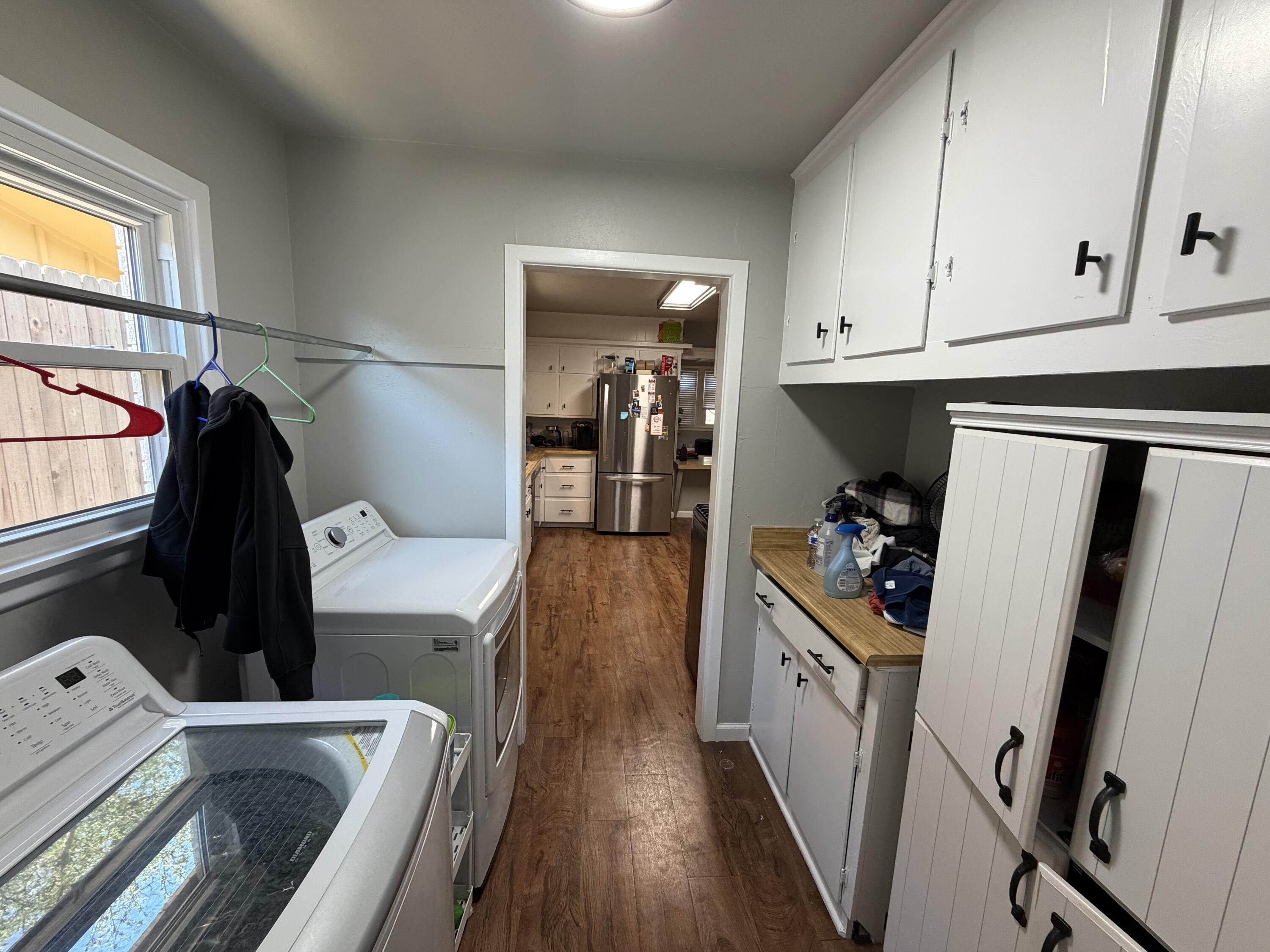 2202 58th Street Lubbock, TX 79412 - Photo 12 of 37 a walk in closet with wooden floor washer and dryer