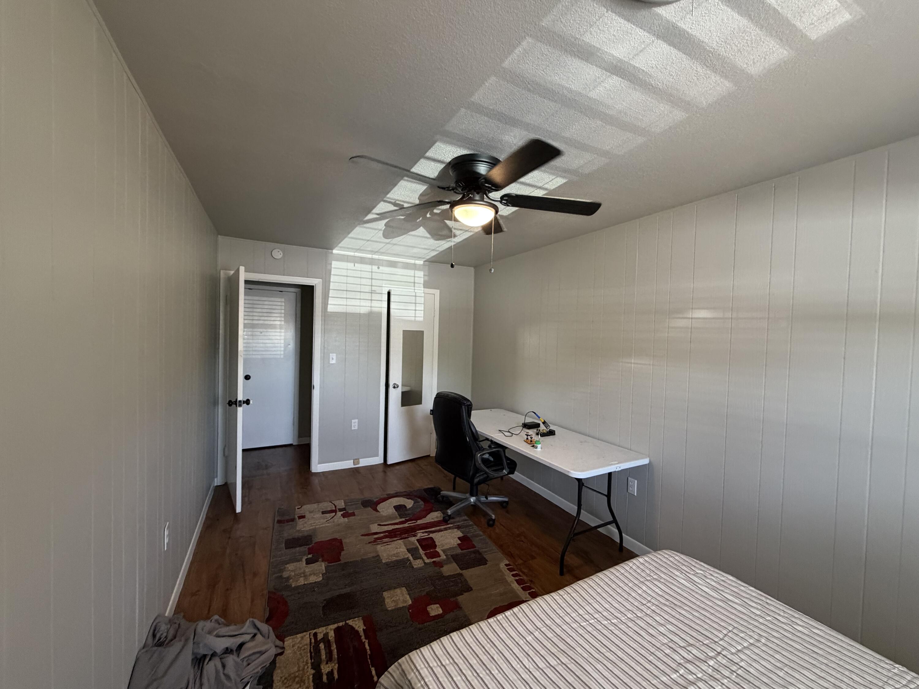 2202 58th Street Lubbock, TX 79412 - Photo 16 of 37 a bedroom with a bed and a chandelier fan