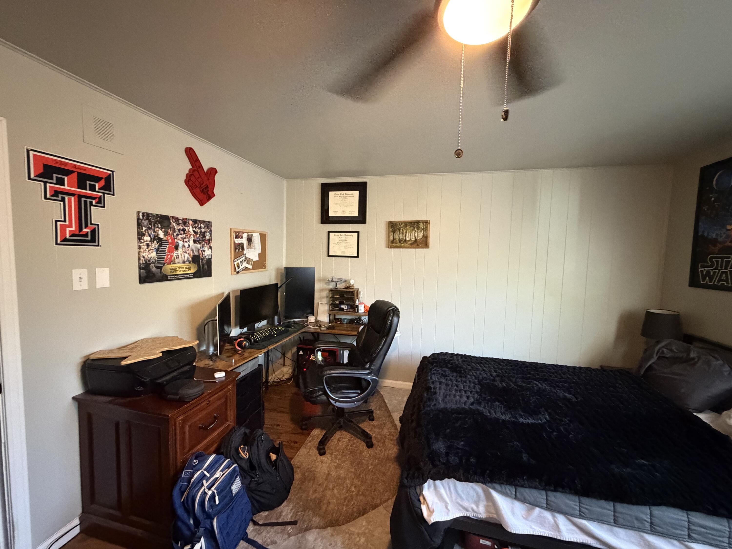 2202 58th Street Lubbock, TX 79412 - Photo 19 of 37 a living room with furniture and a flat screen tv
