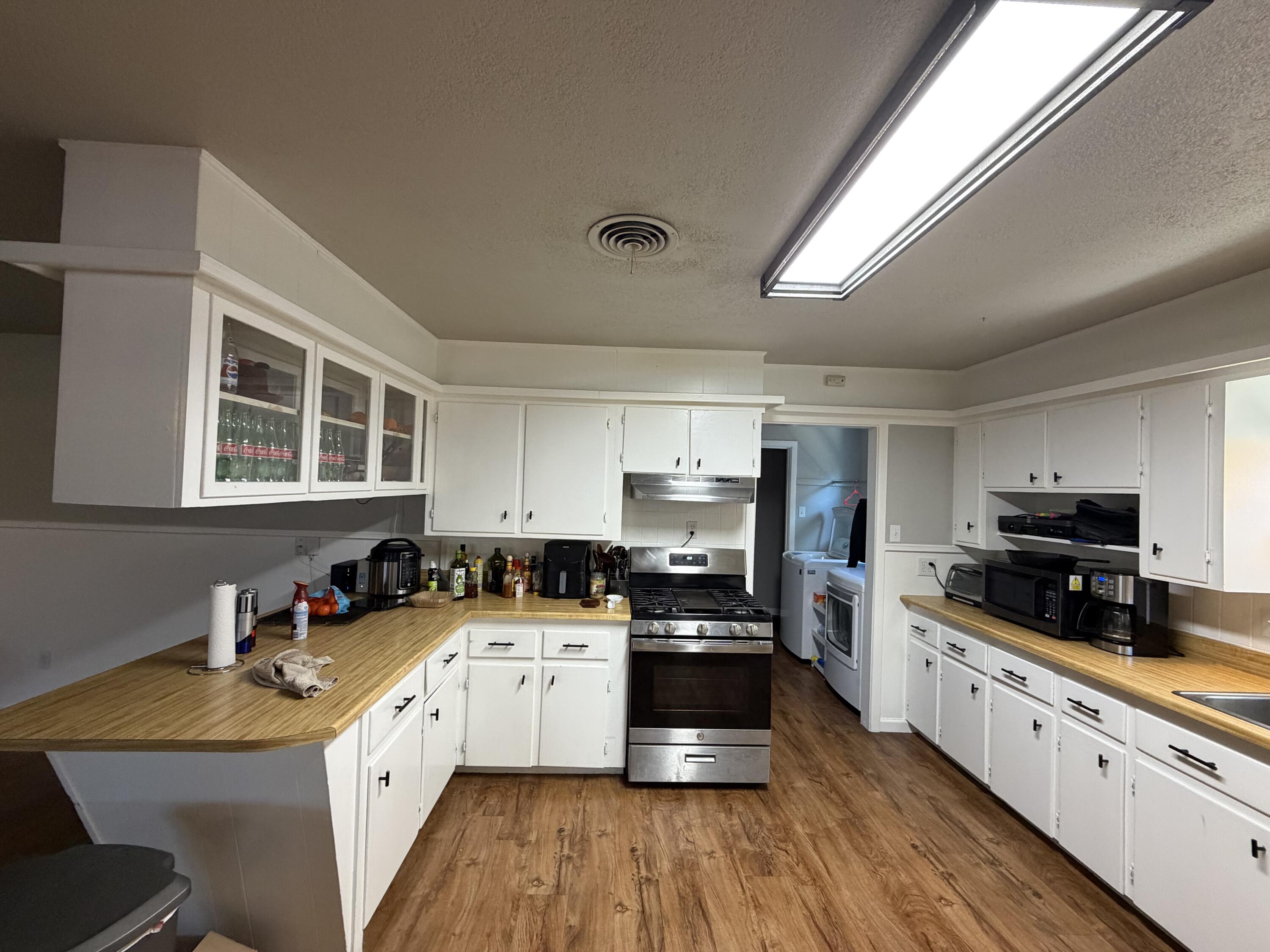 2202 58th Street Lubbock, TX 79412 - Photo 2 of 37 a kitchen with granite countertop a sink a counter top space appliances and cabinets