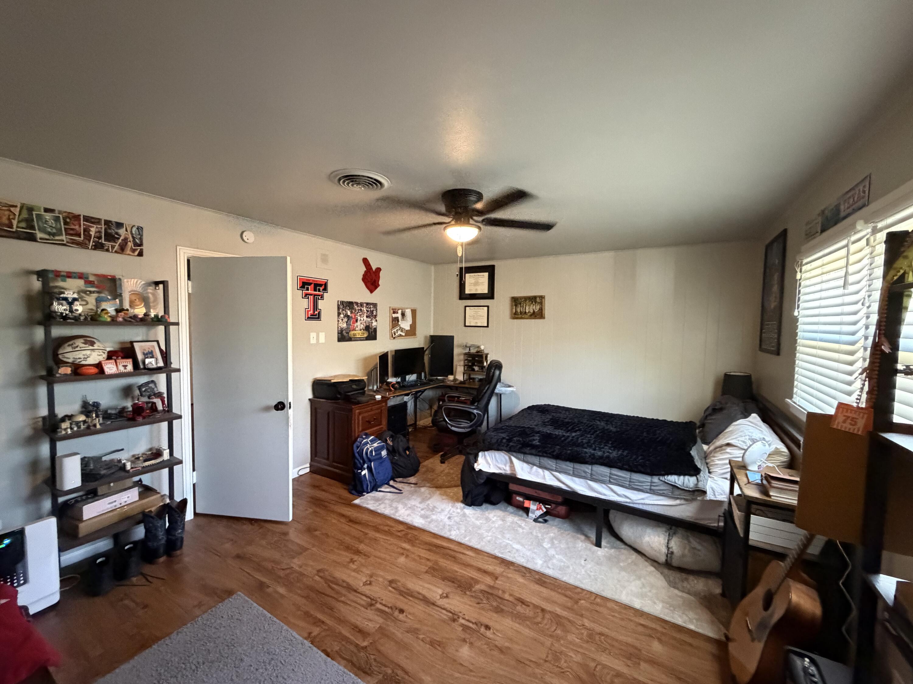 2202 58th Street Lubbock, TX 79412 - Photo 21 of 37 a living room with furniture and a book shelf
