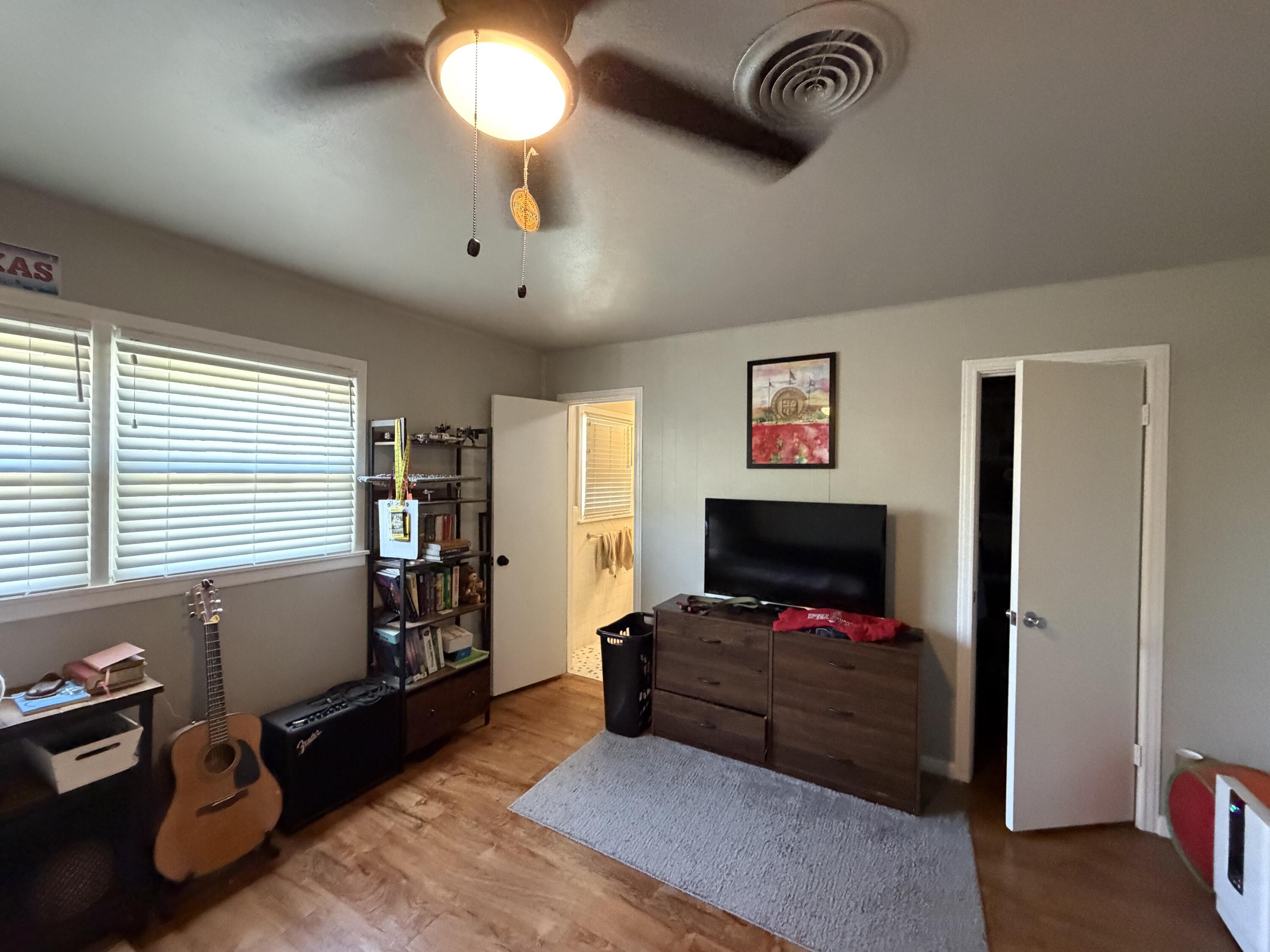 2202 58th Street Lubbock, TX 79412 - Photo 22 of 37 a living room with furniture gym equipment and a window