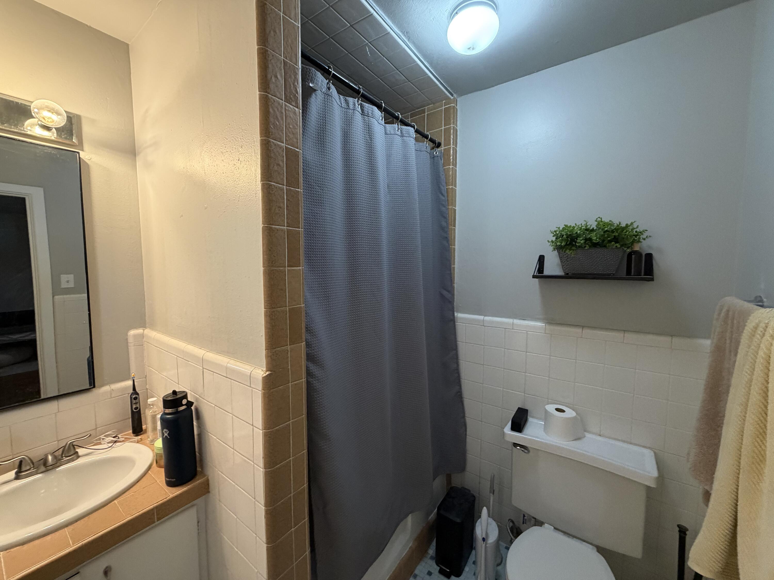 2202 58th Street Lubbock, TX 79412 - Photo 24 of 37 a bathroom with a sink toilet and shower